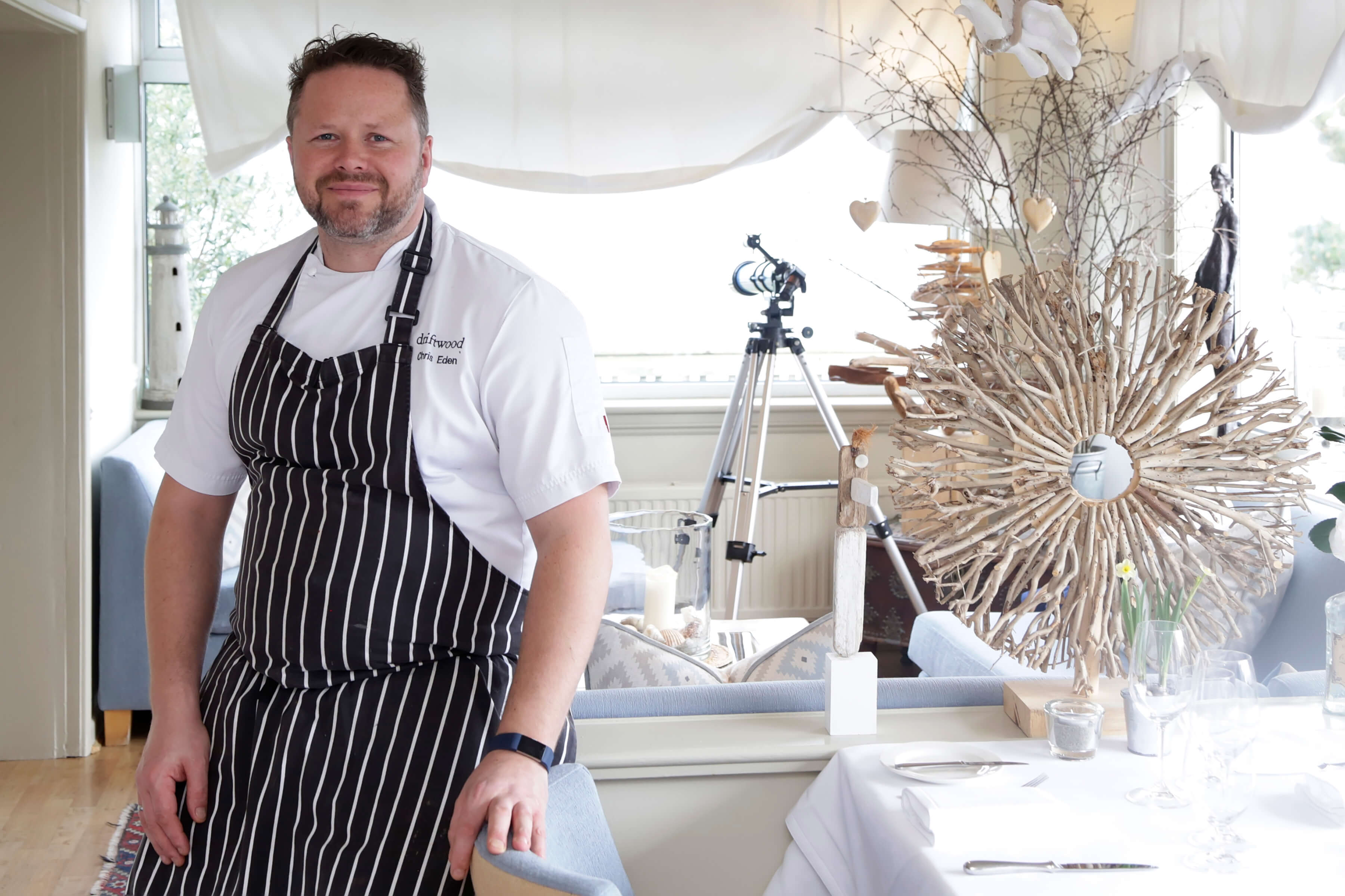 Chris Eden head chef at the Driftwood hotel relaxing in the restaurant